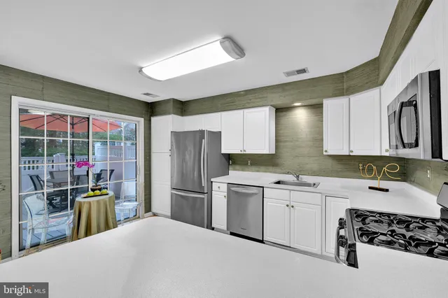 a kitchen with a sink appliances and cabinets