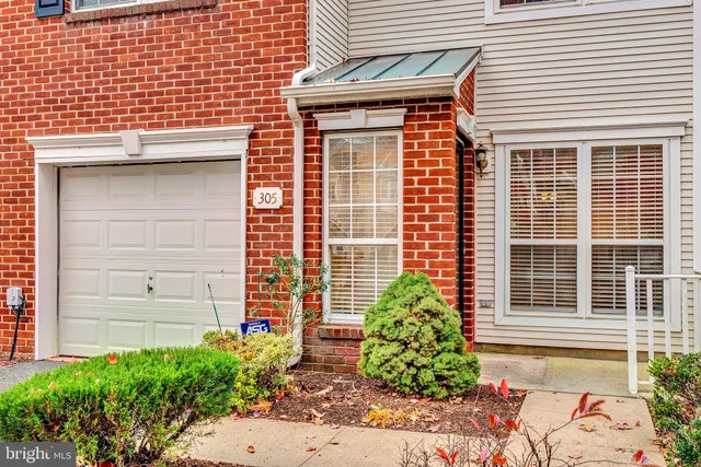 a front view of a house with plants