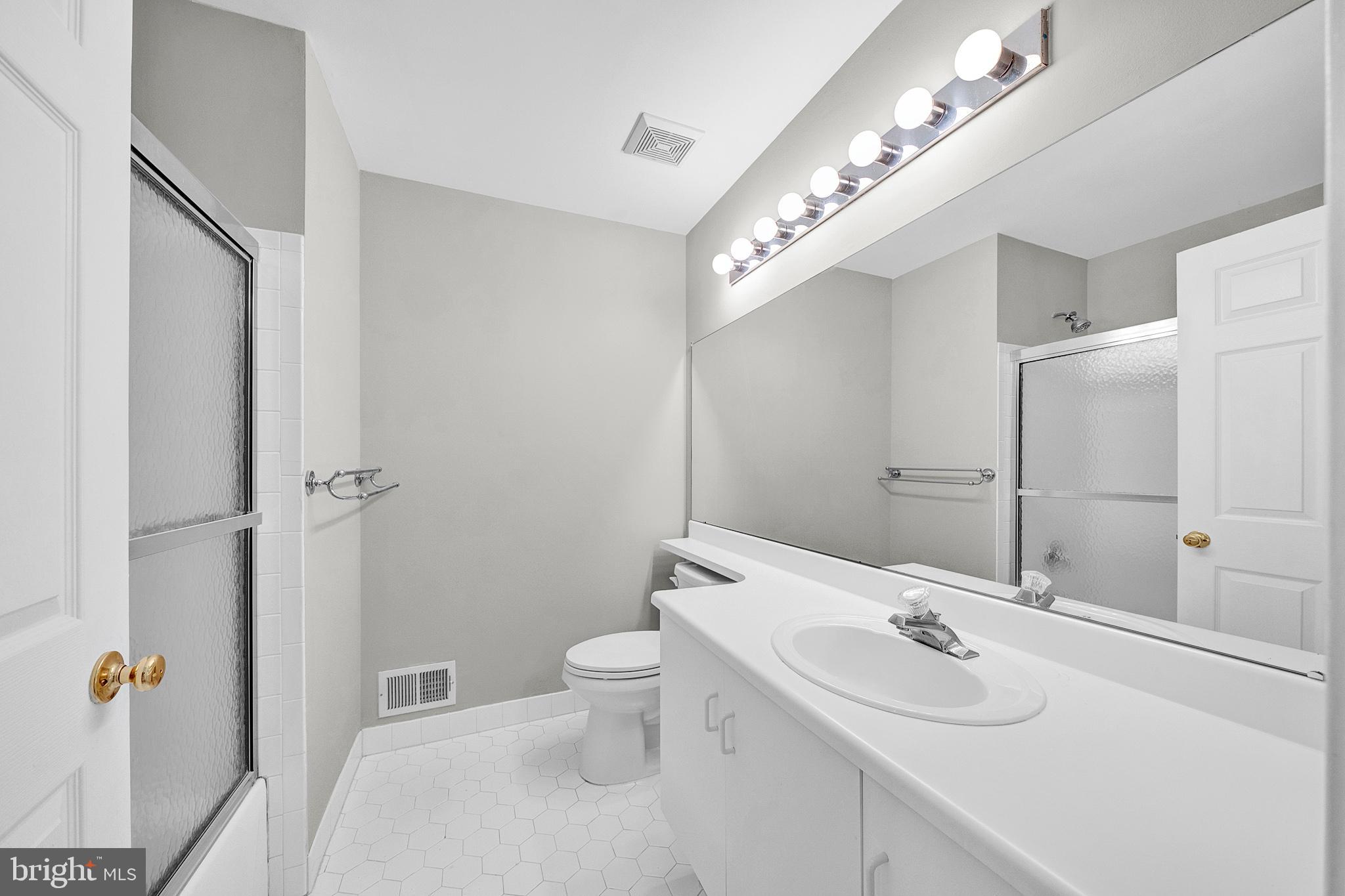 305 Deer Run Court Pennington, NJ 08534 - Photo 28 of 34 a bathroom with a sink a toilet and shower