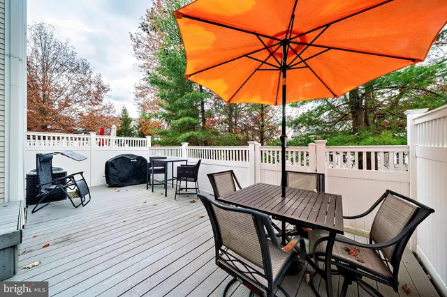a view of a patio with a table and chairs