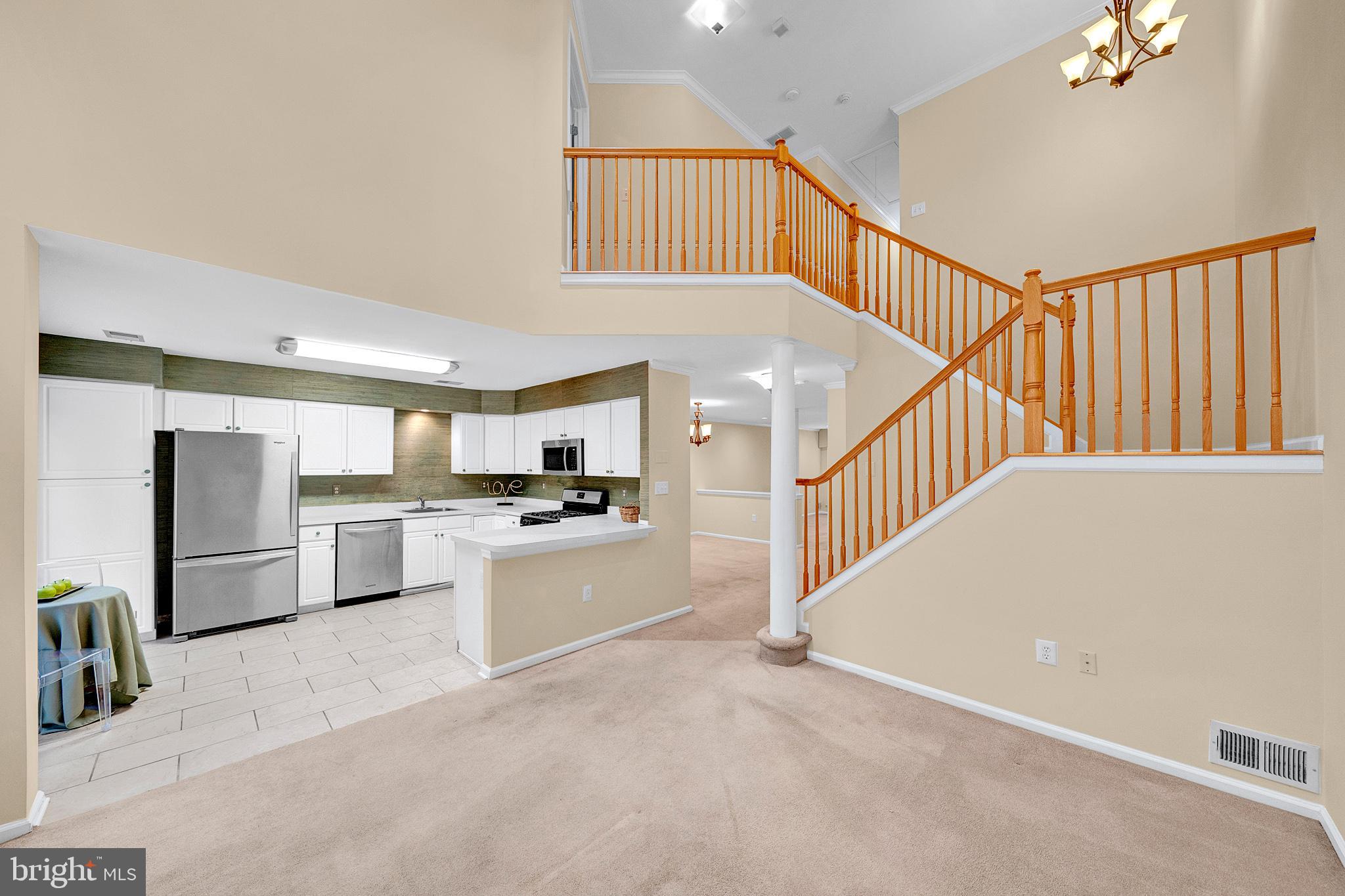 305 Deer Run Court Pennington, NJ 08534 - Photo 10 of 34 a view of a kitchen with a sink cabinets and a living room