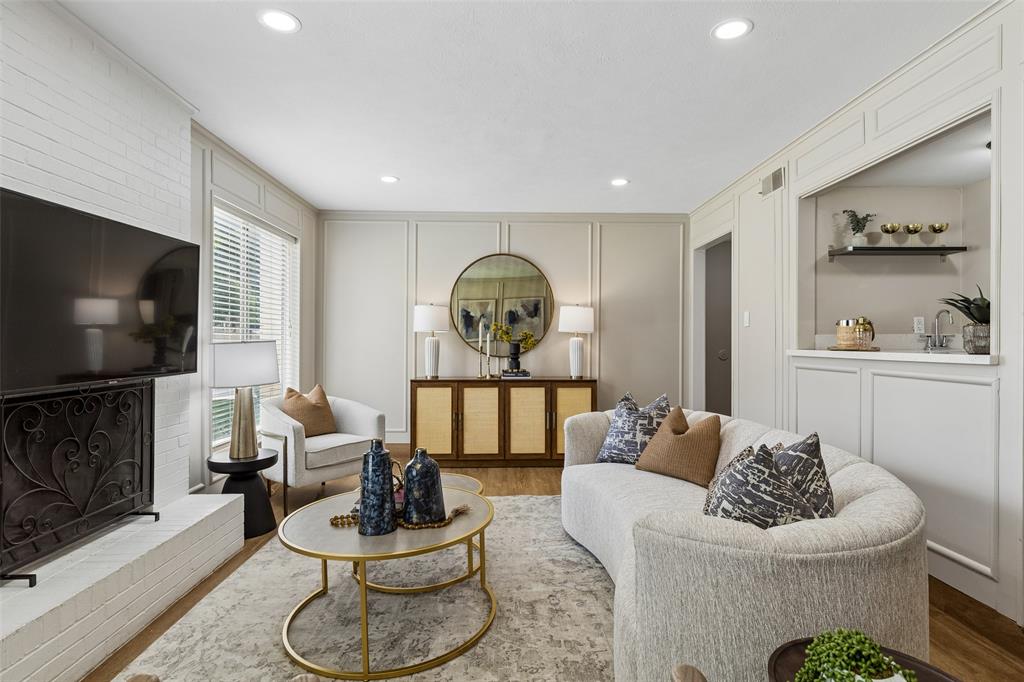 4962 Thunder Road Dallas, TX 75244 - Photo 15 of 26 Living area featuring recessed lighting, a white brick fireplace, wood-finish flooring, and a built-in wet bar with shelving