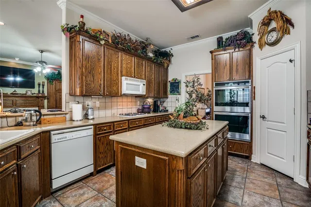 a kitchen with a sink a stove and cabinets
