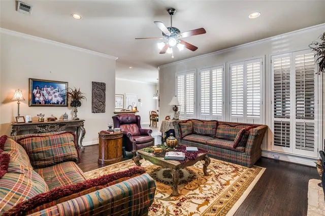 a living room with furniture ceiling fan and a rug