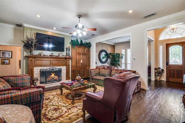 a living room with furniture a flat screen tv and a fireplace