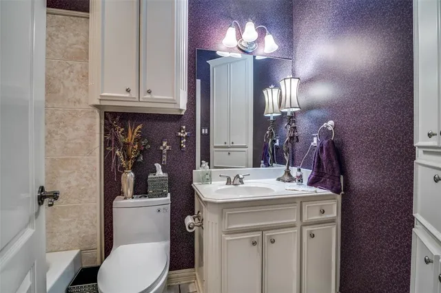a bathroom with a sink a toilet and mirror