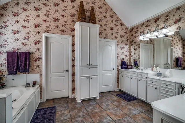 a room with white cabinets and sink