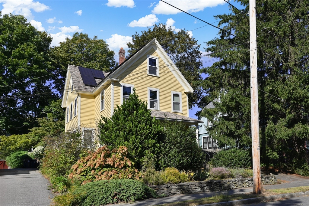 a front view of a house with a yard and fountain