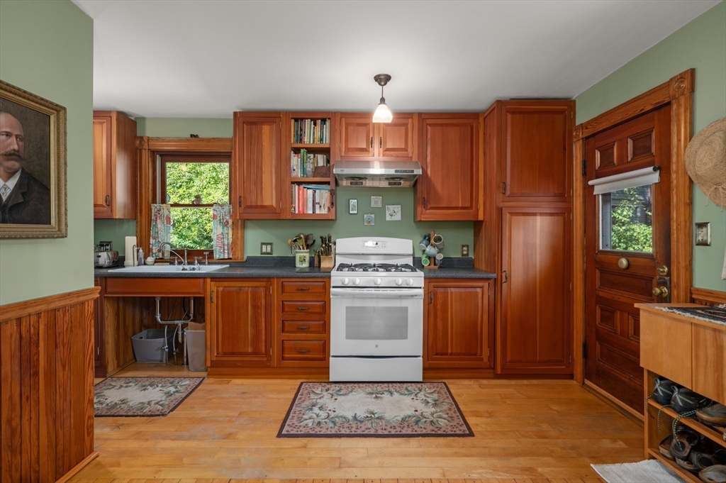 14 Summer Street Andover, MA 01810 - Photo 13 of 31 a kitchen with kitchen island granite countertop a stove top oven cabinets and a refrigerator
