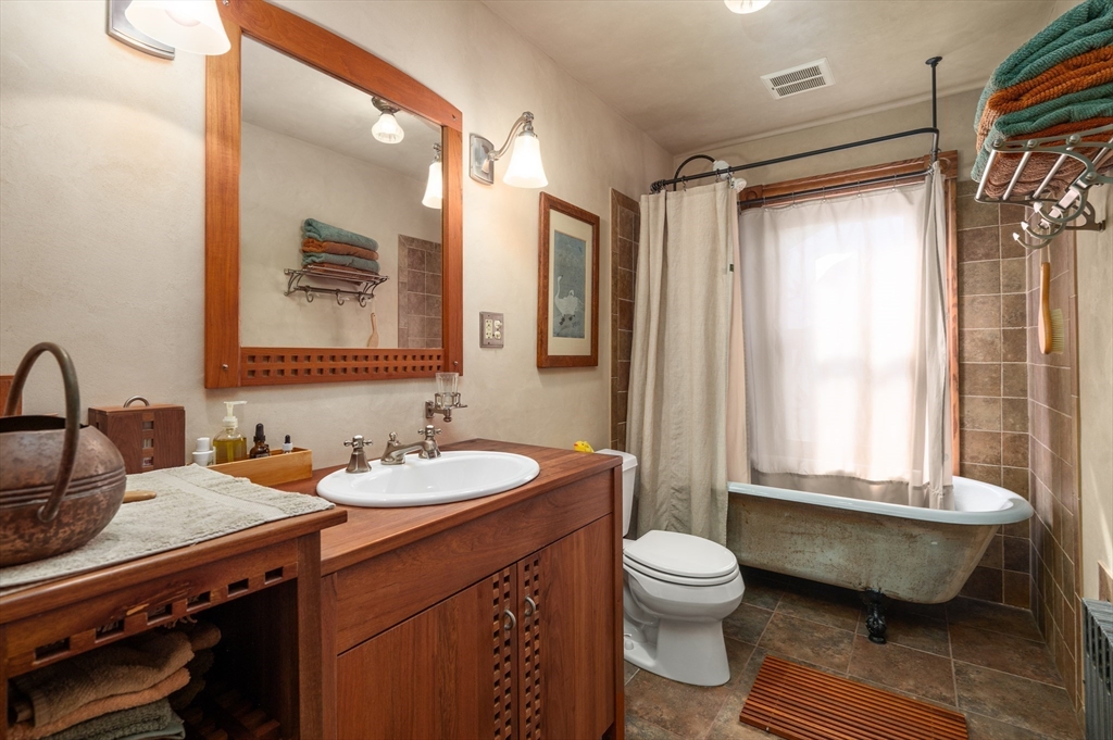 14 Summer Street Andover, MA 01810 - Photo 20 of 31 a bathroom with a granite countertop sink toilet a large mirror a bathtub and shower