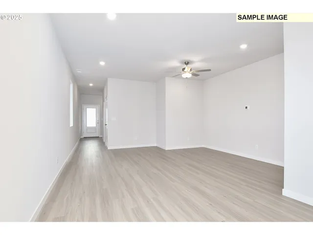 a view of an empty room with a ceiling fan