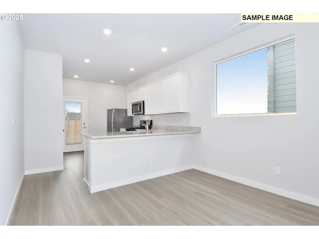 a view of kitchen with wooden floor