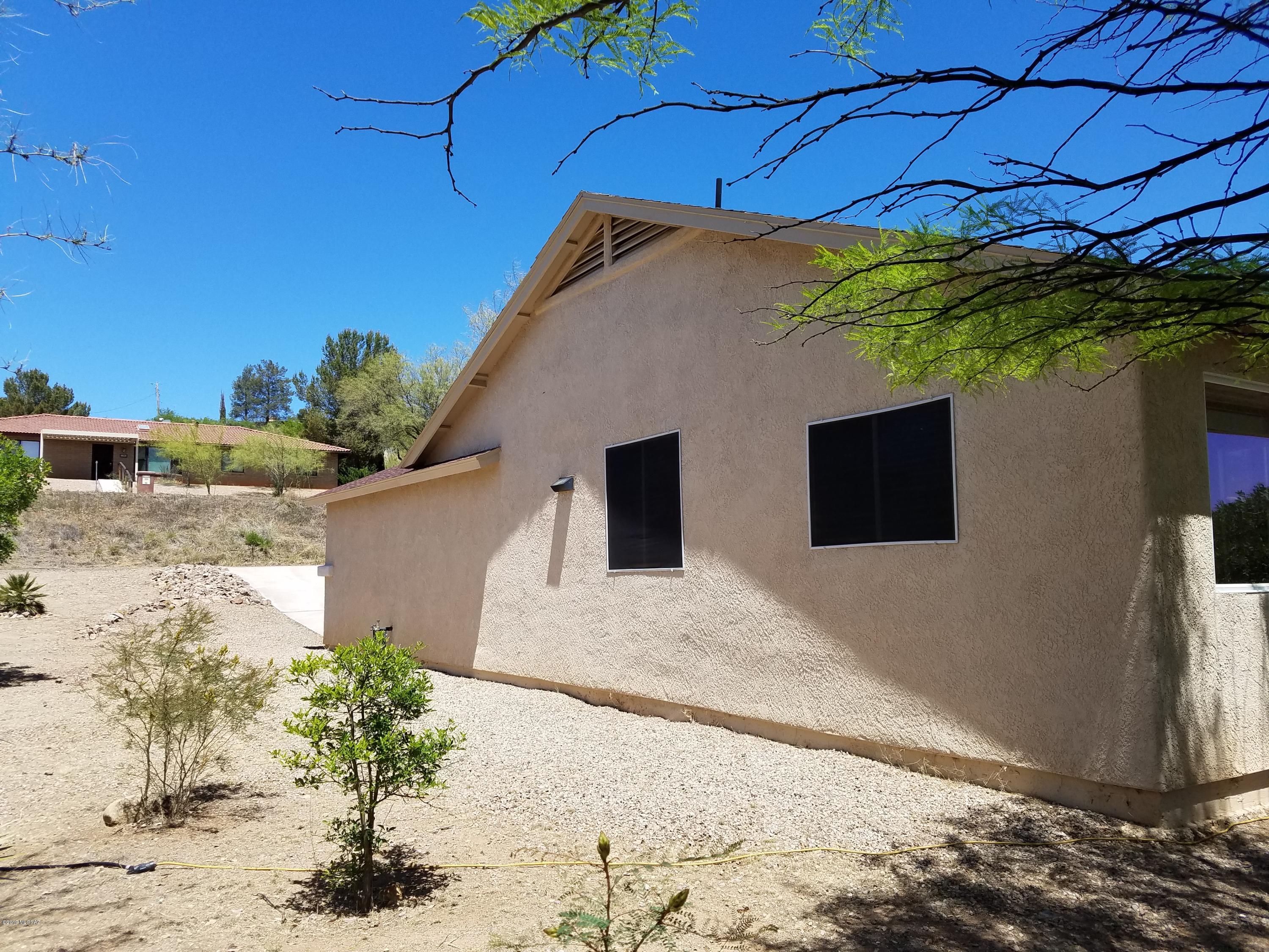 1175 Avenida Leon Rio Rico, AZ 85648 - Photo 8 of 24 a view of a house with a yard and potted plants