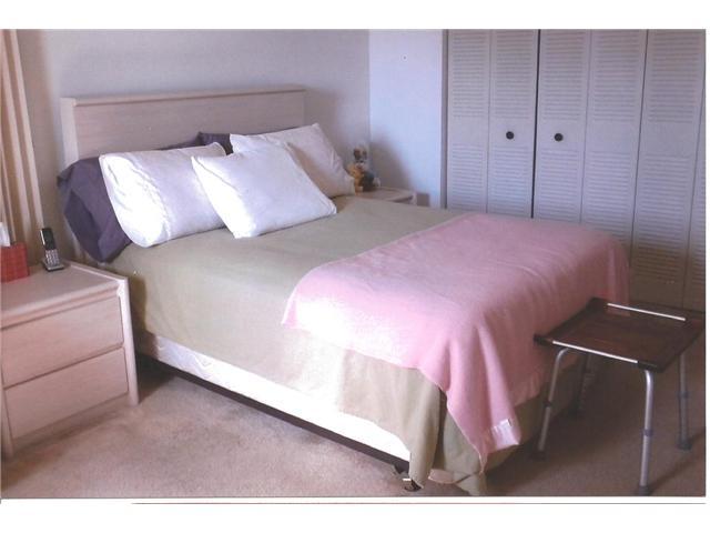 409 Saxony Way, Unit 409 Delray Beach, FL 33446 - Photo 2 of 8 a bedroom with a bed and a night stand