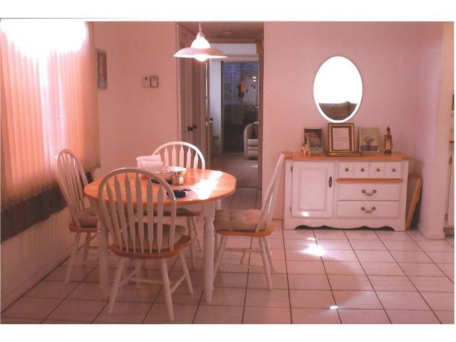 409 Saxony Way, Unit 409 Delray Beach, FL 33446 - Photo 3 of 8 a dining room with furniture and wooden floor