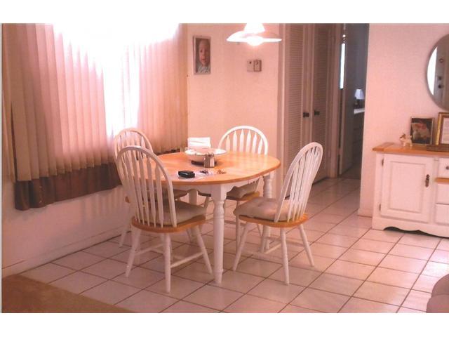 409 Saxony Way, Unit 409 Delray Beach, FL 33446 - Photo 8 of 8 a view of a dining room with furniture and a window