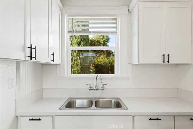 a kitchen with a sink and cabinets