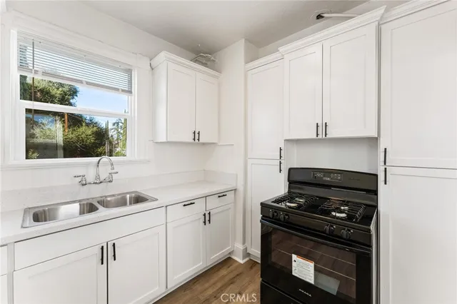 a kitchen with a sink stove and cabinets