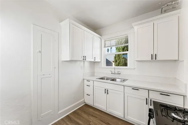 a kitchen with a sink cabinets and window