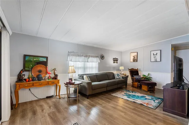 a living room with furniture or couch and a wooden floor