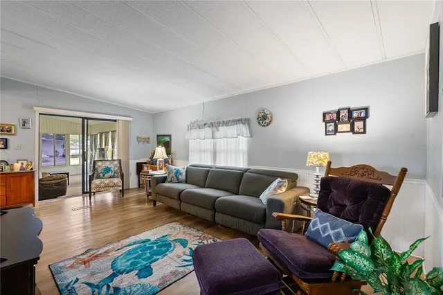 a living room with furniture a dining table and a flat screen tv