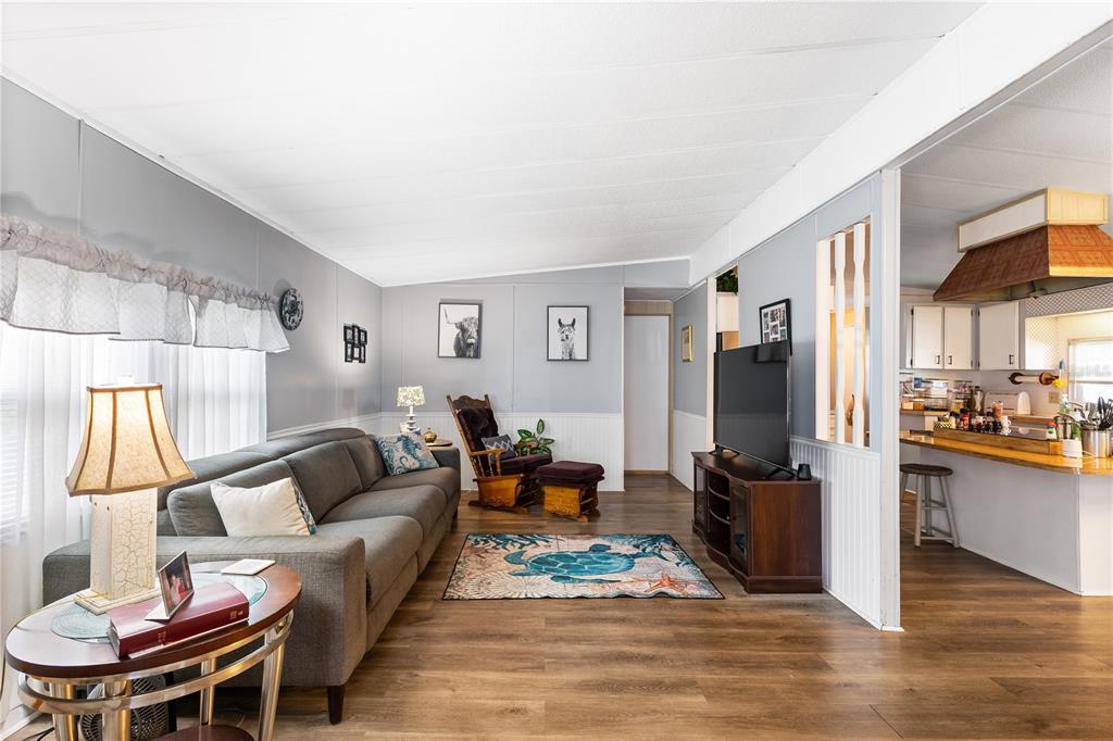 26 Da-Rosa Avenue DeBary, FL 32713 - Photo 15 of 45 a living room with furniture a dining table and a refrigerator