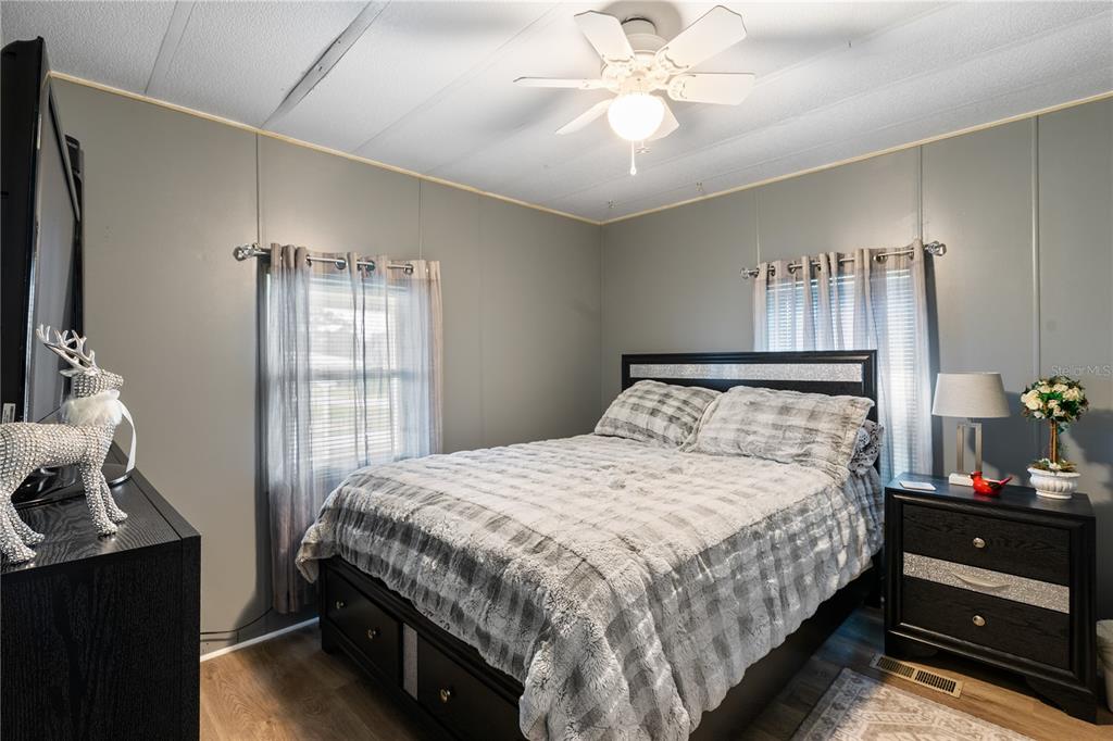 26 Da-Rosa Avenue DeBary, FL 32713 - Photo 16 of 45 a bedroom with a bed and a chandelier