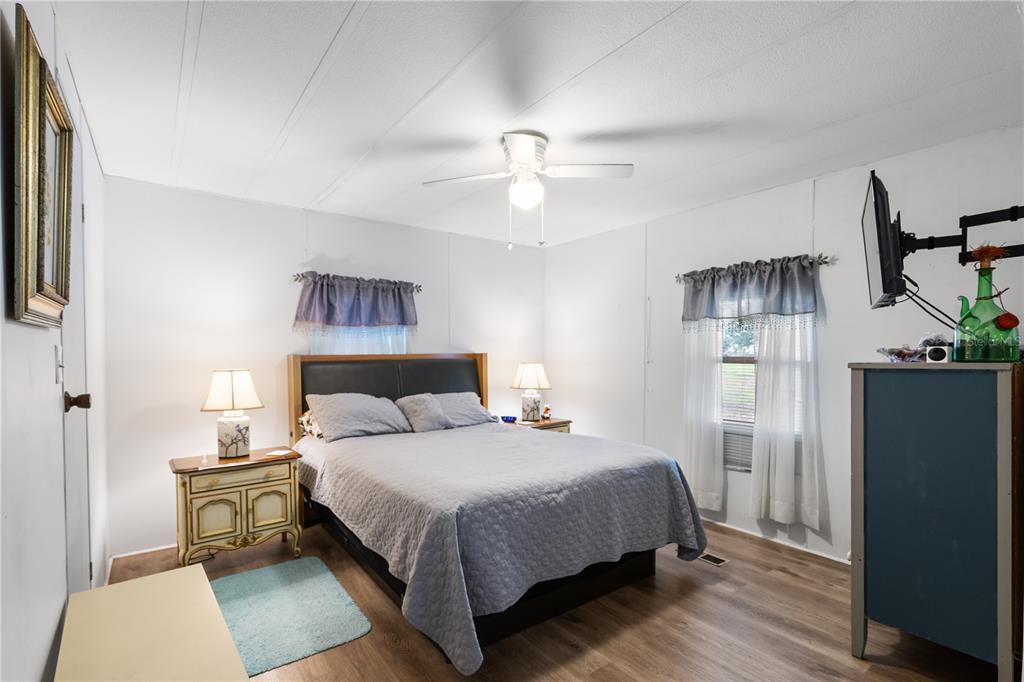 26 Da-Rosa Avenue DeBary, FL 32713 - Photo 18 of 45 a bedroom with a bed and a chandelier