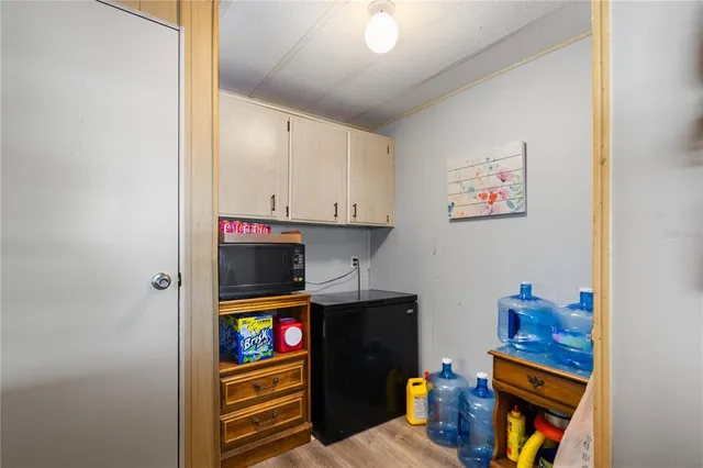 a living room with furniture a flat screen tv and a large window