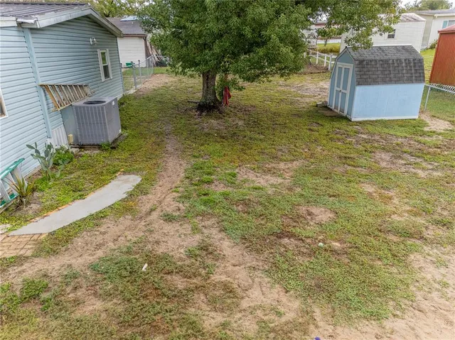 a view of a yard with a house and a tree