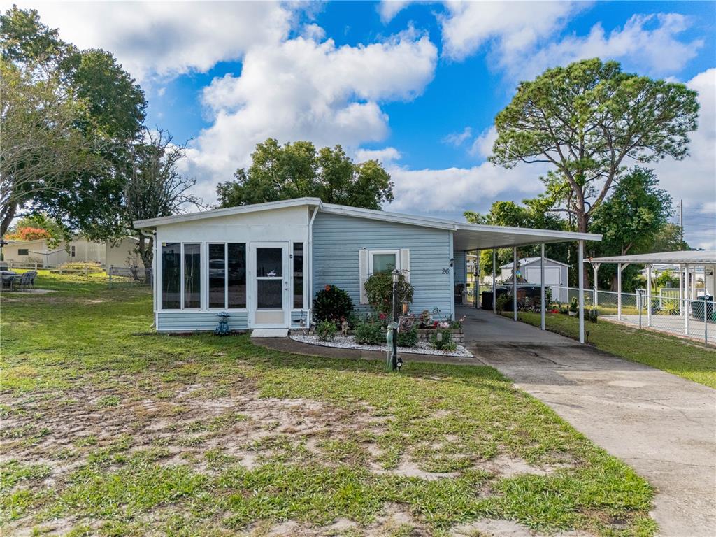 26 Da-Rosa Avenue DeBary, FL 32713 - Photo 3 of 45 a front view of house with a garden and porch