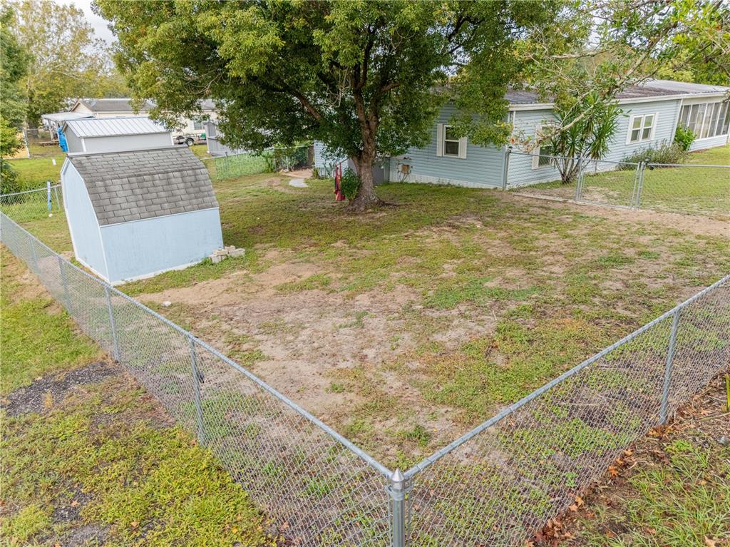 26 Da-Rosa Avenue DeBary, FL 32713 - Photo 33 of 45 a view of a backyard with a tree