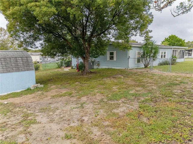 a backyard of a house with yard and garage