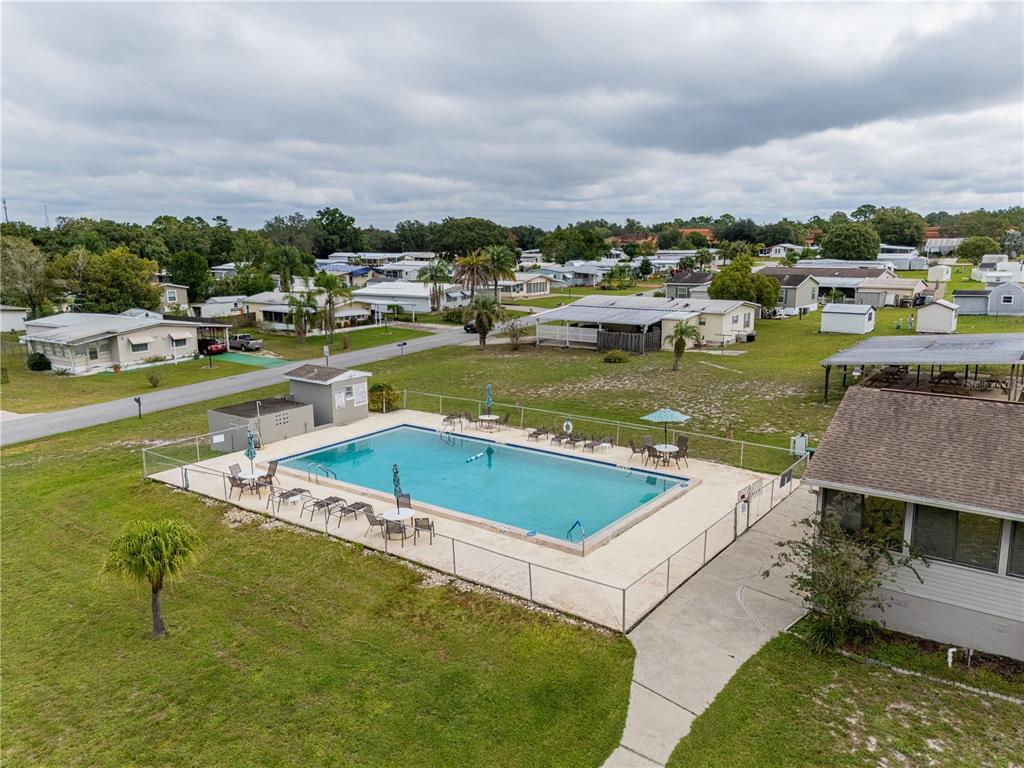 26 Da-Rosa Avenue DeBary, FL 32713 - Photo 40 of 45 a view of a swimming pool with lawn chairs