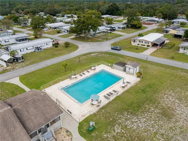 an aerial view of a house with a swimming pool