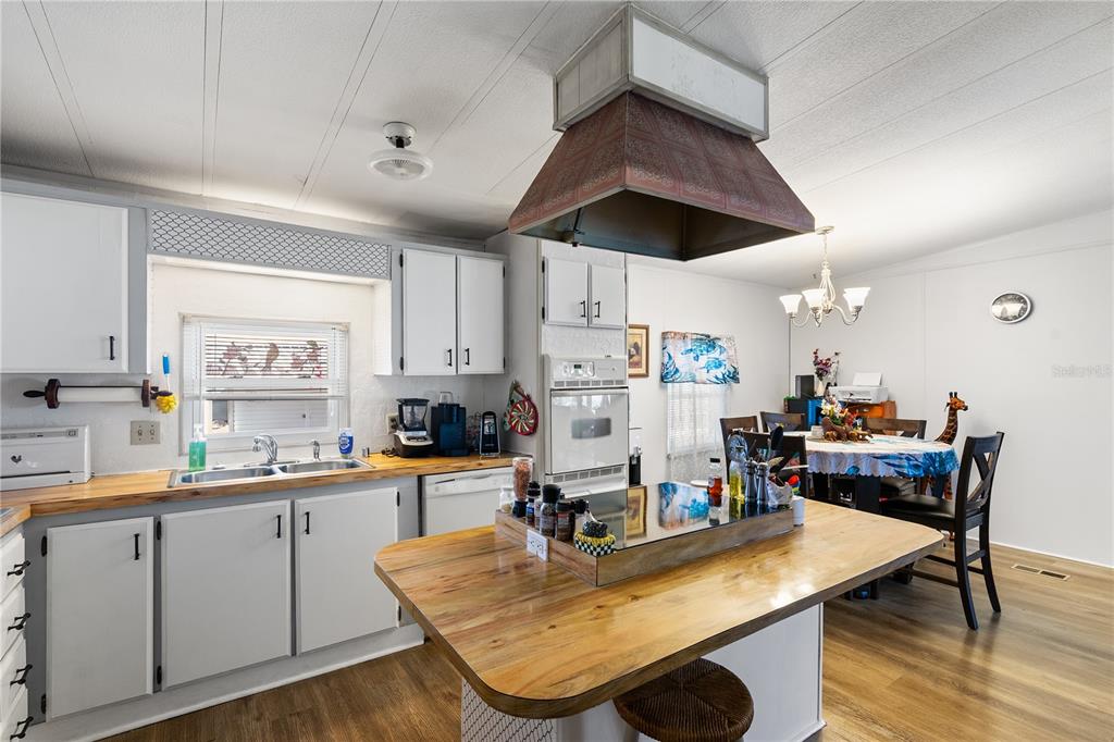 26 Da-Rosa Avenue DeBary, FL 32713 - Photo 8 of 45 a room with stainless steel appliances kitchen island granite countertop a table chairs and a refrigerator