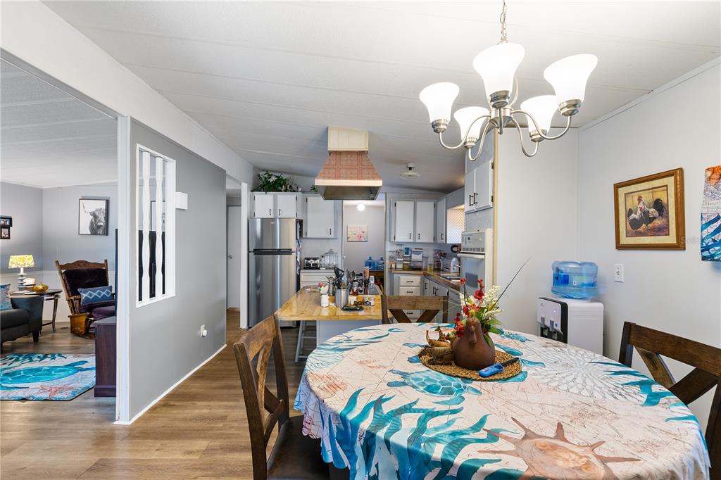 26 Da-Rosa Avenue DeBary, FL 32713 - Photo 9 of 45 a view of a dining room with furniture a chandelier and wooden floor
