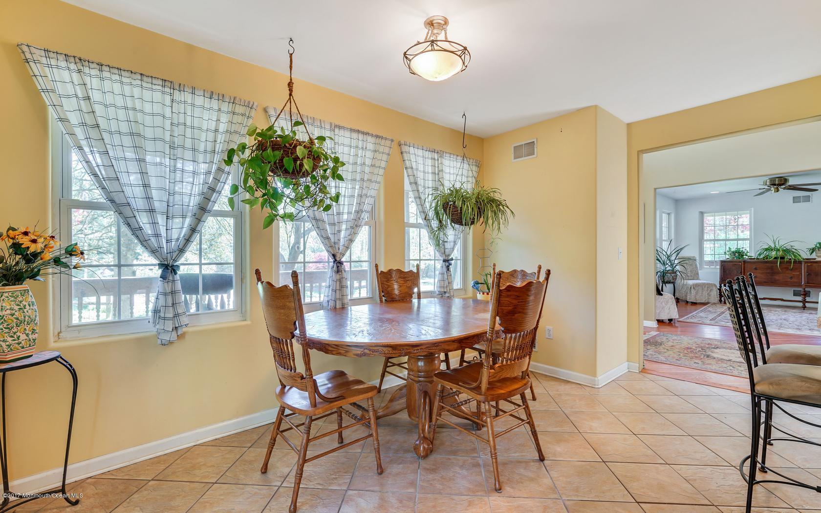 460 North County Line Road Jackson, NJ 08527 - Photo 19 of 48 a view of a dining room with furniture and a potted plant