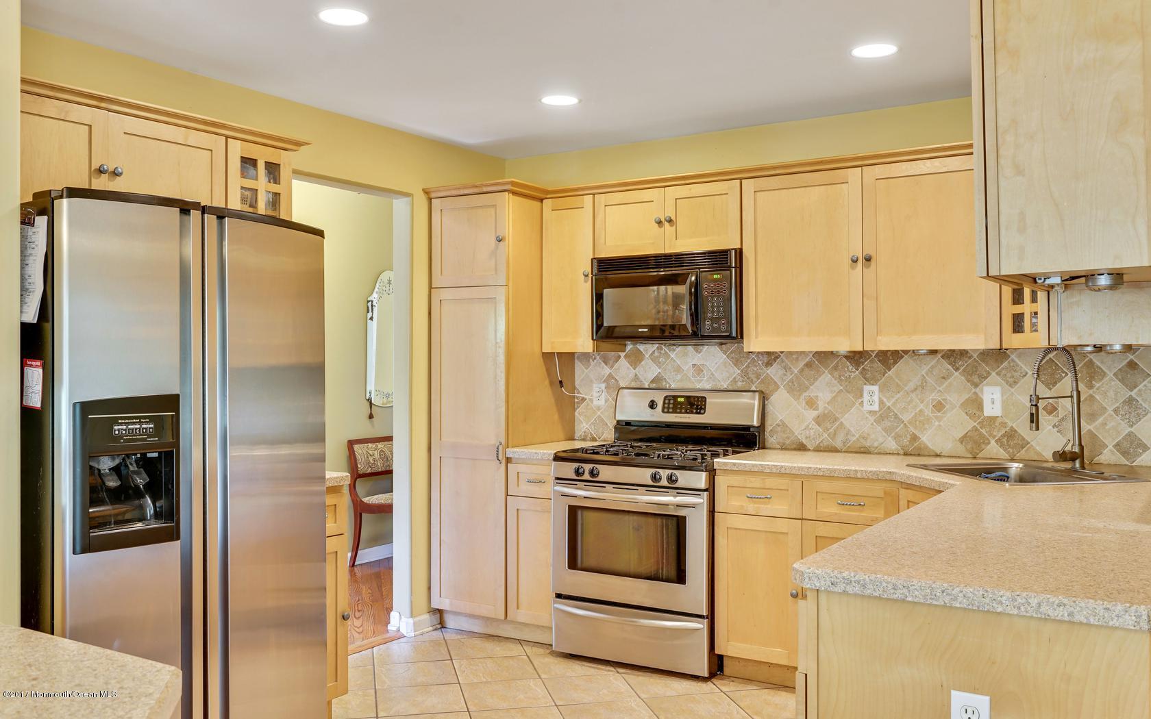 460 North County Line Road Jackson, NJ 08527 - Photo 21 of 48 a kitchen with stainless steel appliances granite countertop a refrigerator a stove and a sink with wooden floor
