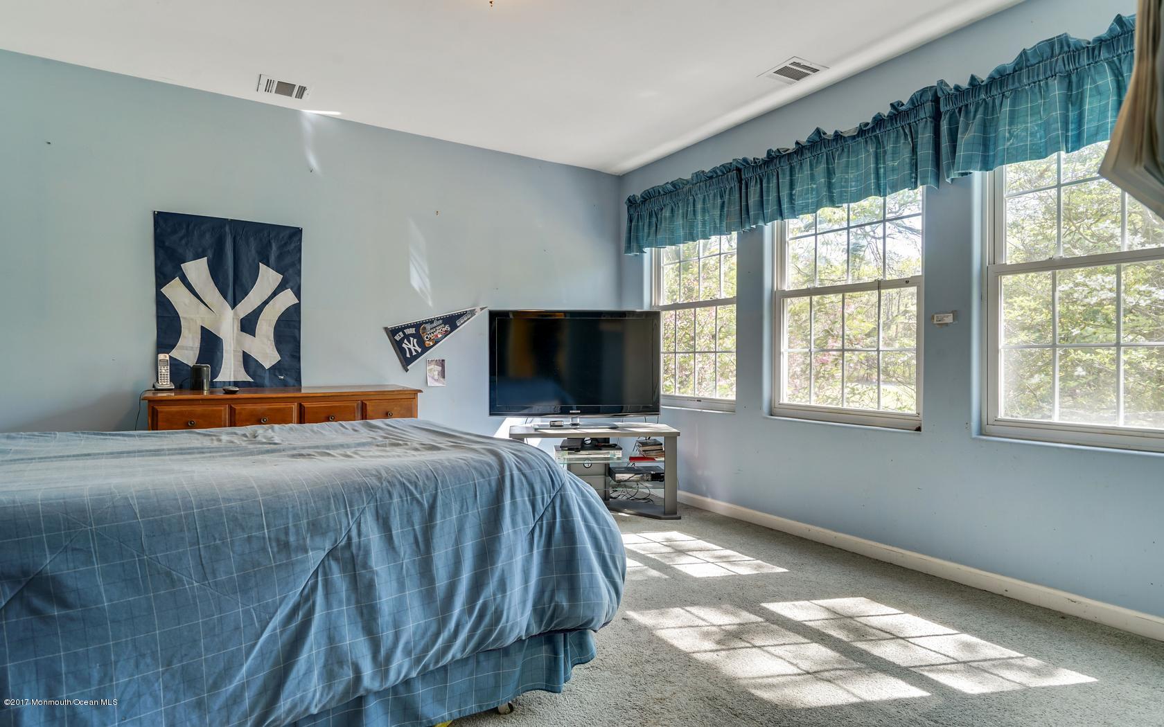 460 North County Line Road Jackson, NJ 08527 - Photo 34 of 48 a bedroom with furniture and flat screen tv