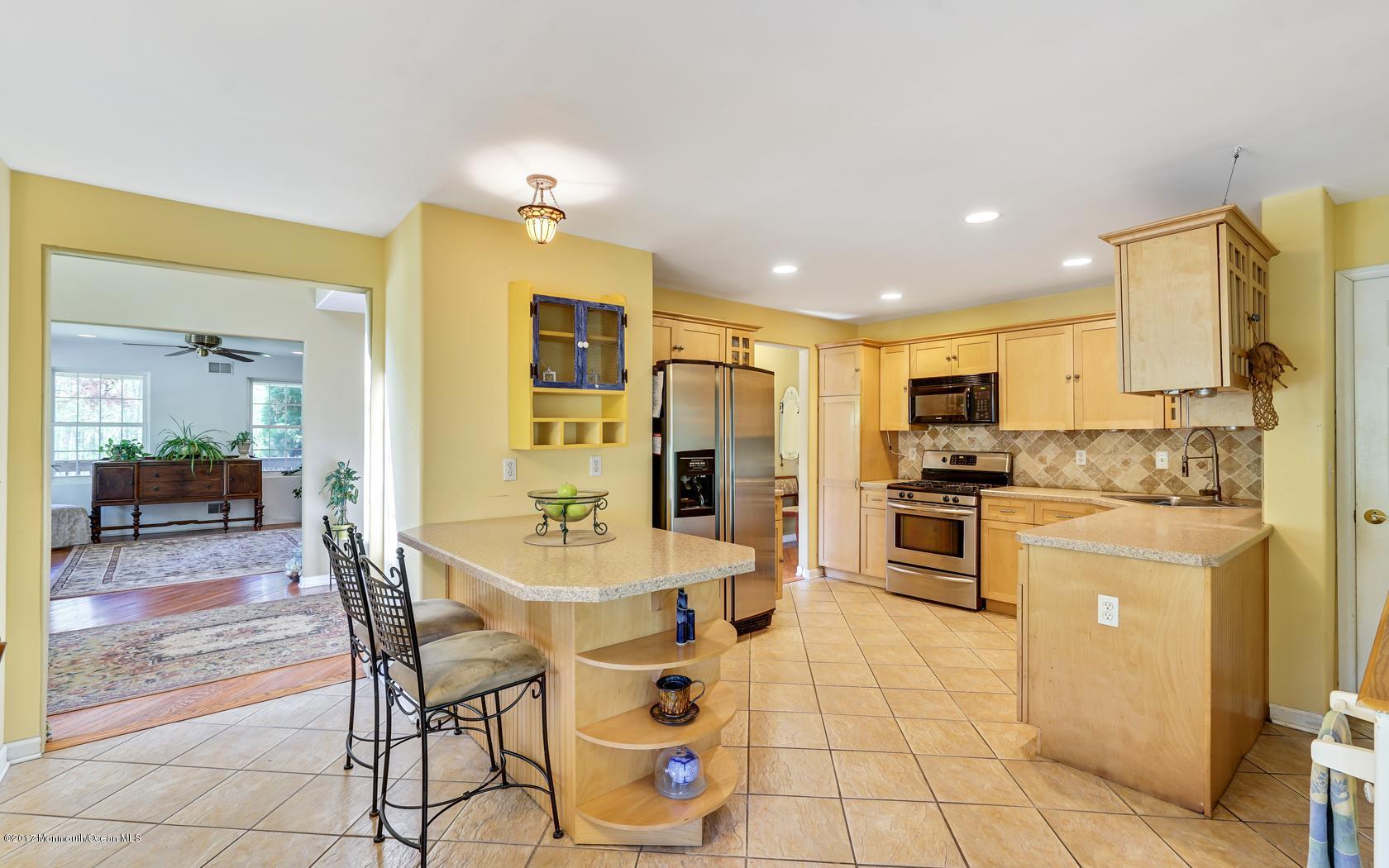 460 North County Line Road Jackson, NJ 08527 - Photo 5 of 48 a kitchen with stainless steel appliances a refrigerator sink stove dining table and chairs