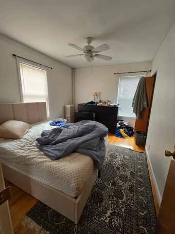 a bedroom with bed couch and window