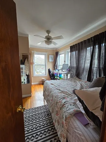 a bed sitting in a spacious bedroom next to a window
