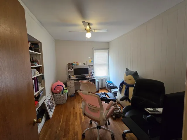 a view of a workspace with furniture and a flat screen tv