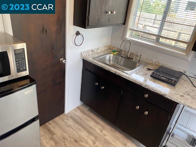 514 Talbot Avenue, Unit 514B Albany, CA 94706 - Photo 3 of 12 a kitchen with a sink a stove and a microwave