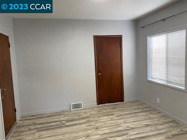 514 Talbot Avenue, Unit 514B Albany, CA 94706 - Photo 7 of 12 a view of an empty room with wooden floor and a window