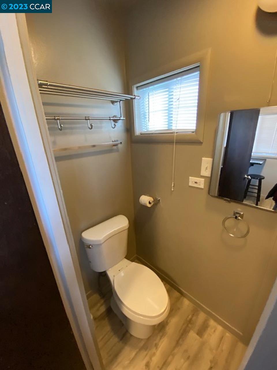 514 Talbot Avenue, Unit 514B Albany, CA 94706 - Photo 9 of 12 a bathroom with a toilet sink and mirror