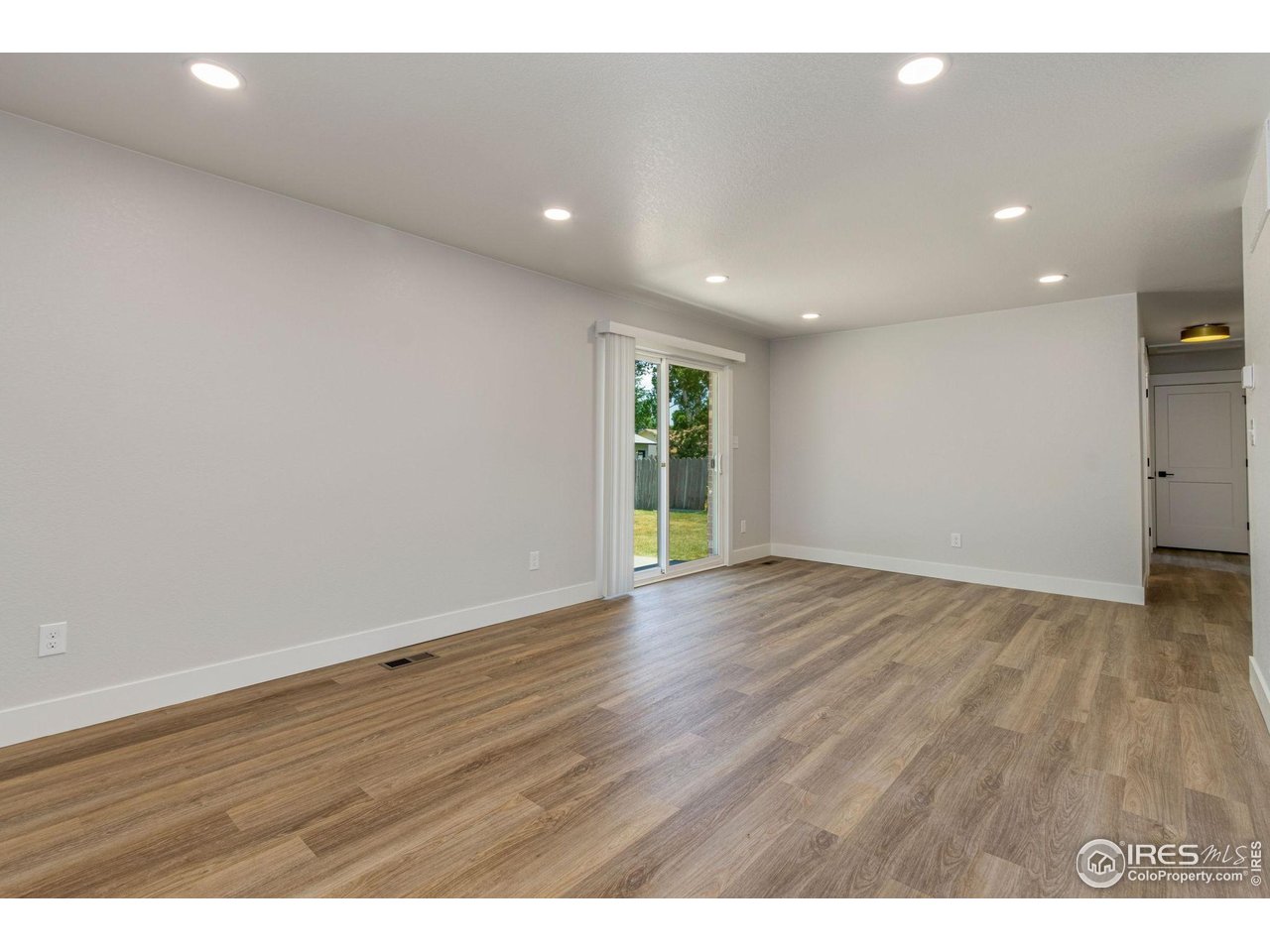 812 Rocky Road Fort Collins, CO 80521 - Photo 9 of 19 a view of an empty room with wooden floor