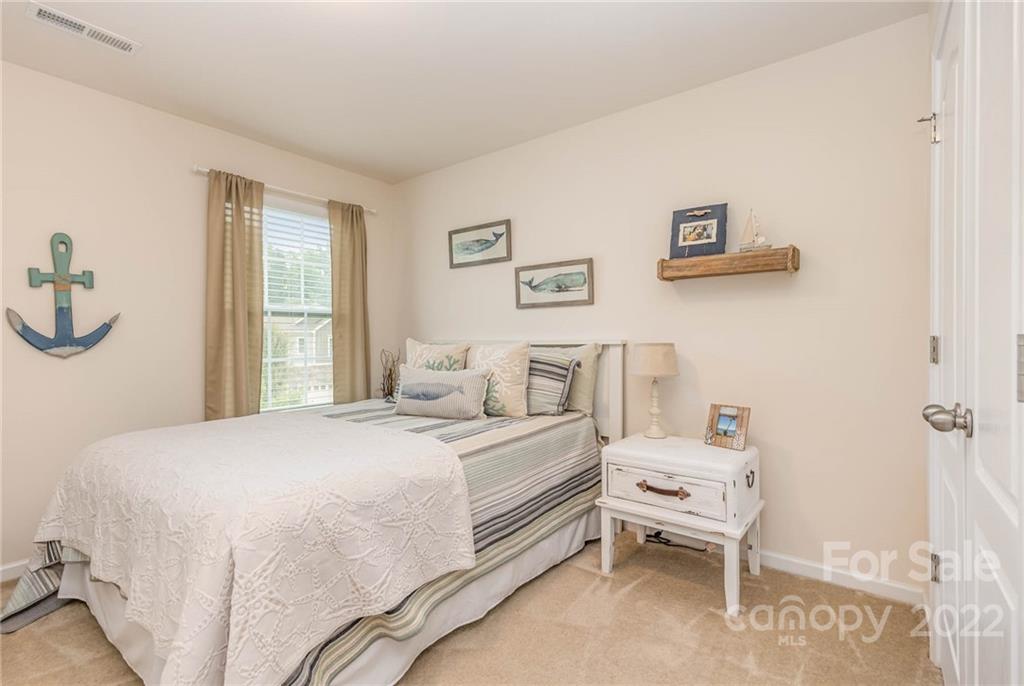1563 Spring Blossom Trail Fort Mill, SC 29708 - Photo 20 of 25 a bedroom with a bed and a window