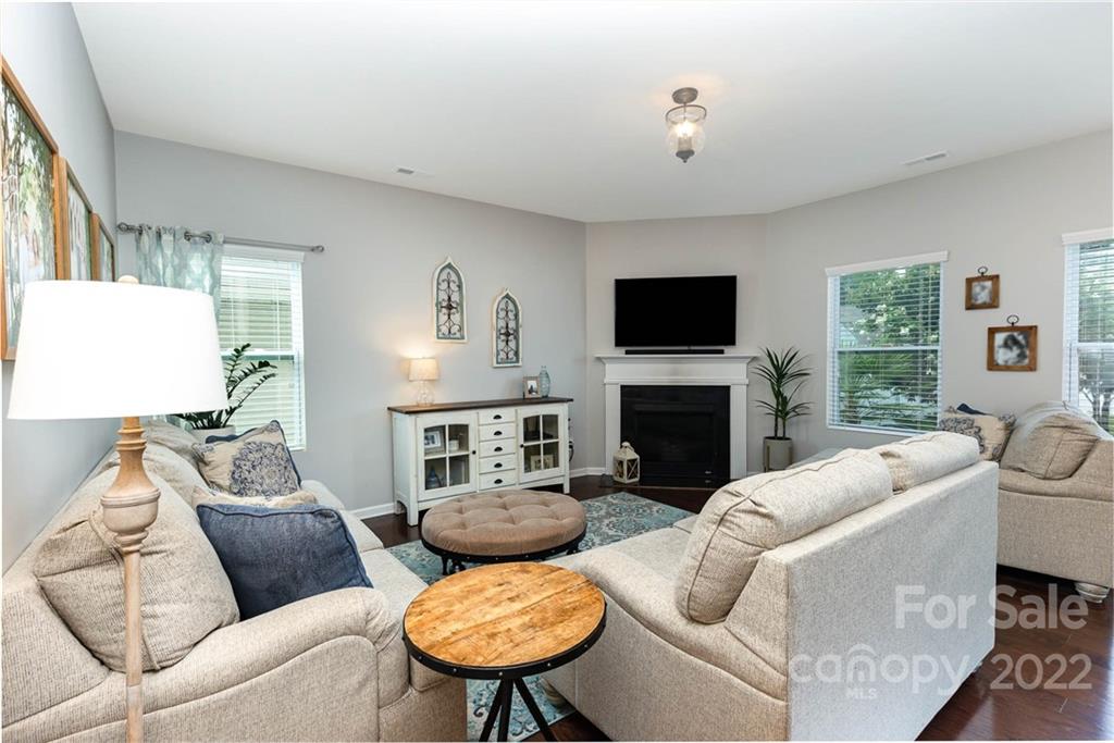 1563 Spring Blossom Trail Fort Mill, SC 29708 - Photo 2 of 25 a living room with furniture a fireplace and a flat screen tv